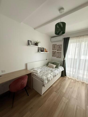 a bedroom with a bed and a desk and a desk at Stanza a Saint Paul Bay in St. Paul's Bay
