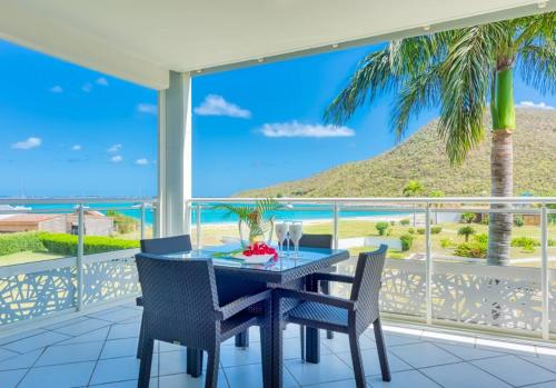 a dining room with a view of the ocean at Le Domaine Anse Marcel Beach Resort in Anse Marcel 