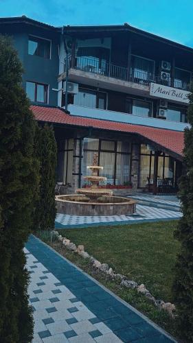 a building with a fountain in front of it at Maribel Spa Hotel in Köprilova