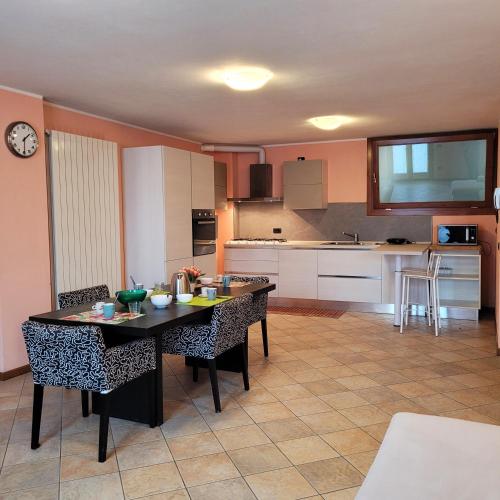 a kitchen with a table and chairs in a room at L'Antico Fienile Mountain Lake Iseo Hospitality in Fonteno