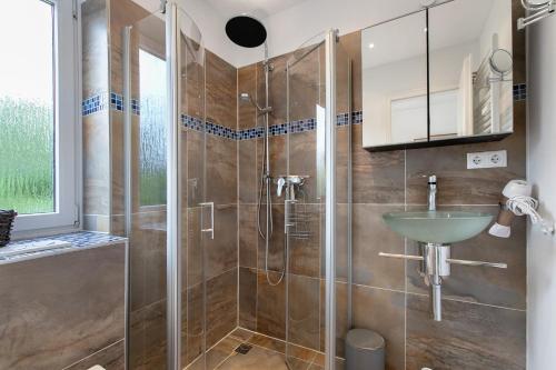a bathroom with a shower and a sink at Häuschen Seerobbe in Böhl