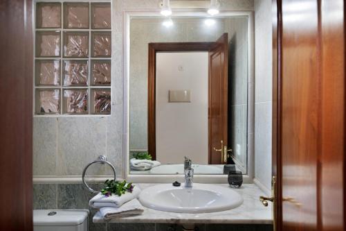 a bathroom with a sink and a mirror at Serendipity in Playa Blanca