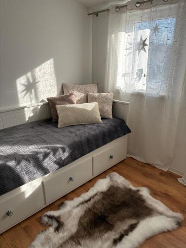 a bedroom with a bed with a window and a rug at Modern Apartment in Bebra