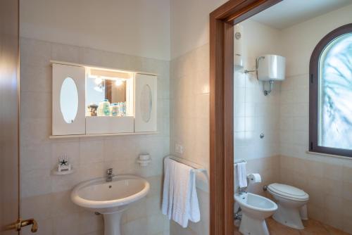 a bathroom with a sink and a toilet at Monolocale 900 in Racale