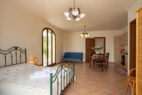 a bedroom with a bed and a dining room at Monolocale 900 in Racale