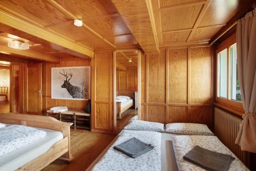 a room with two beds and a picture of a deer at Black Forest Woods in Bernau im Schwarzwald