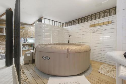 a bathroom with a large tub in a room at La Perle Rosée in Azerat