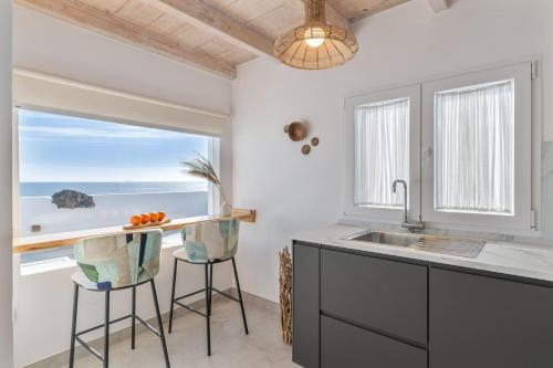 a kitchen with a sink and a counter with a window at El Jable Rentals in Arrieta