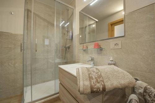 a bathroom with a sink and a glass shower at Il Pellegrino in Issogne