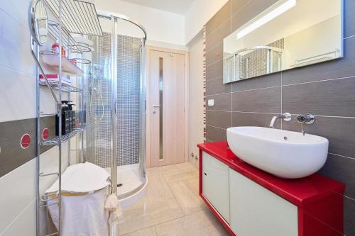 a bathroom with a white sink and a shower at Rosamare - Follonica in Follonica