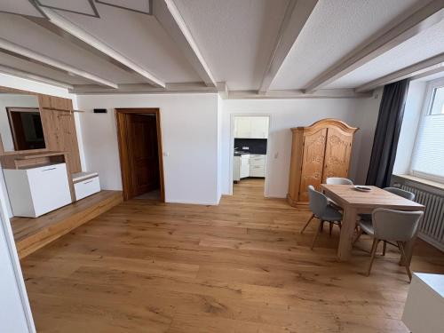 a kitchen and dining room with a table and chairs at Moderne Ferienwohnung Bodensee in Sigmarszell
