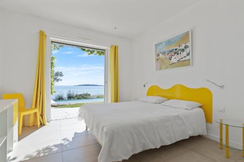 a bedroom with a bed and a large window at Ventaou in Sainte-Maxime