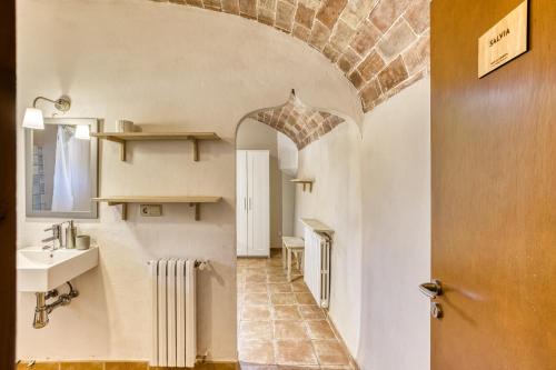 a bathroom with a sink and a mirror in a room at Mas la Ginesta in Borrassá