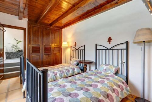 a bedroom with two beds in a room at Palacio Taro Chimida in Teguise