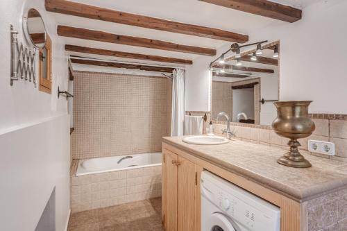 a bathroom with a sink and a bath tub and a sink at Casa Antonia in Sóller