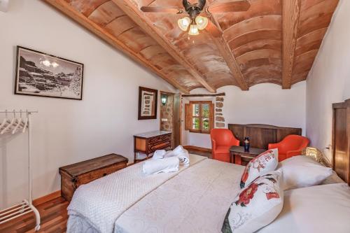 a bedroom with a bed and a wooden ceiling at Casa Antonia in Sóller
