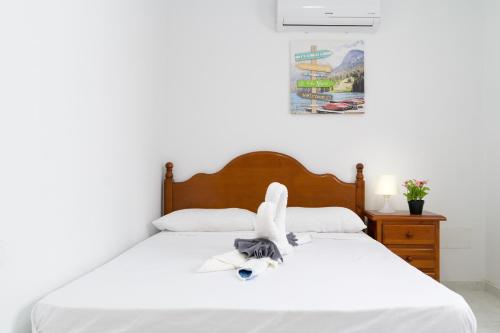 a bedroom with a bed with a stuffed animal on it at Kays studio in Puerto del Carmen