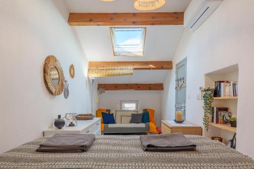 a bedroom with a bed and a living room at Gite Leoannatim in Ruoms
