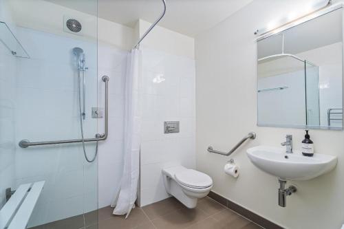 a bathroom with a sink and a toilet and a shower at Villa One on the Waterways - Pool, Spa Pool, Tennis in Whitianga
