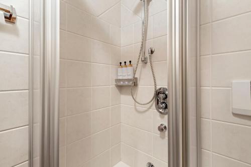a bathroom with a shower with a glass door at Fior di montagna in Bormio
