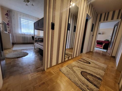 a living room with a mirror and a rug at Ferienwohnung Kleine Bergluft Hahnenklee in Hahnenklee-Bockswiese