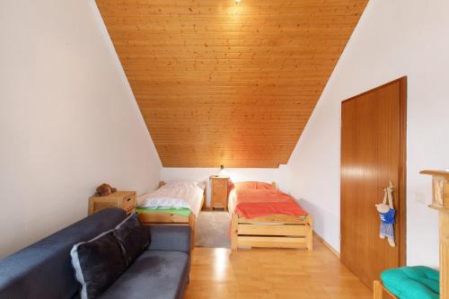 a room with a couch and two beds in it at Haus Domblick in Gückingen