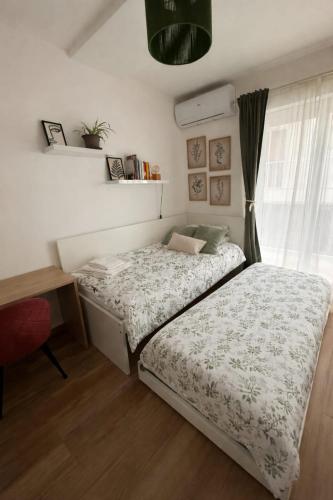 a bedroom with a bed and a desk and a window at Stanza a Saint Paul Bay in St. Paul's Bay
