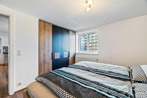 a bedroom with a bed and a window at Apartments Winder 2 in Lustenau