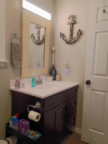 a bathroom with a sink and a mirror at Rustic River Cabin in Branford