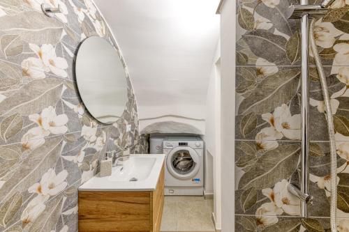 a bathroom with a washing machine and a sink at Casa Don Michele in Specchia