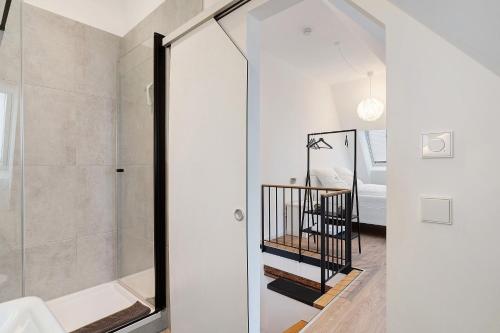 a bathroom with a walk in shower and a glass door at Historisches Forstamt in Gernsbach