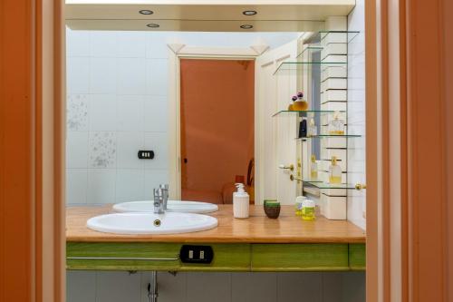a bathroom with a sink and a mirror at Villa Dany with pool in Villa Castelli