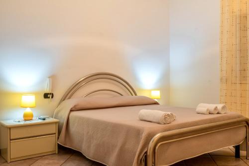 a bedroom with a bed with two towels on it at Villa Dany with pool in Villa Castelli