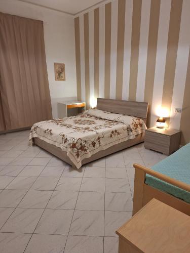 a bedroom with a bed and two night stands and lamps at Giada Apartment in Calenzano