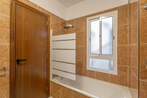 a bathroom with a shower and a window at Las Cucharitas in La Guancha