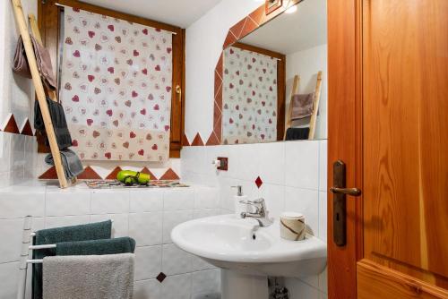 a bathroom with a sink and a mirror at Maison Cerise Pila in Gressan