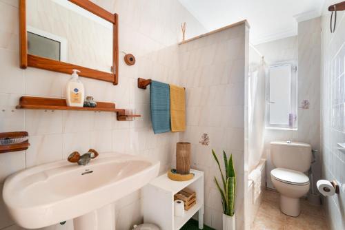 a bathroom with a sink and a toilet and a mirror at Siempreviva in Gáldar