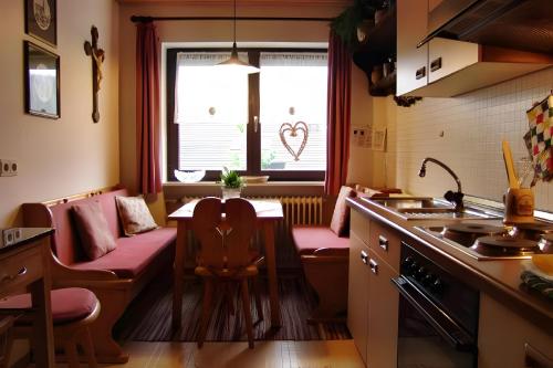 a kitchen with a table and chairs and a window at Ferienwohnung Ritter in Oberharmersbach