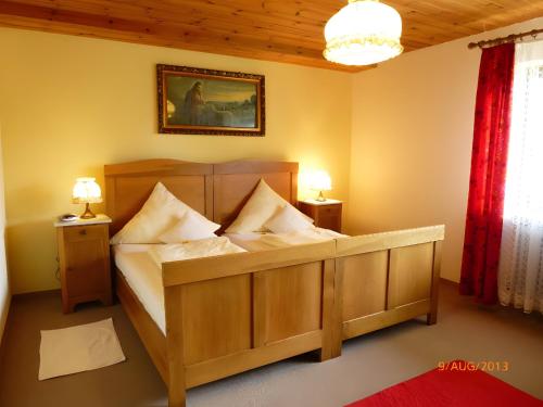 a bedroom with a wooden bed with pillows on it at Ferienwohnung Ritter in Oberharmersbach