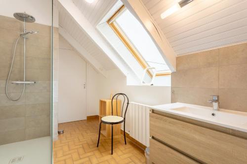 a bathroom with a sink and a shower at La longère familiale et authentique in Melgven