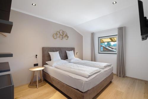 a bedroom with a bed and a window at Premium App Hofer Heidi in Villabassa
