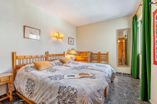 a bedroom with a bed with a book on it at El Tesorillo Andalúz in Almuñécar