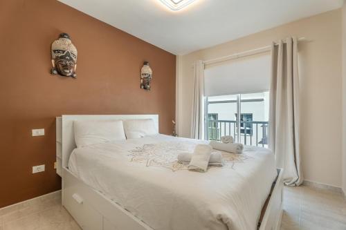 a bedroom with a large white bed with a window at Las Cucharitas in La Guancha