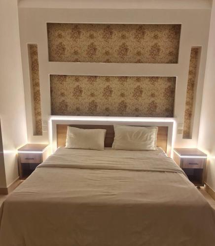 a bedroom with a large bed with two pillows at شاطئ الحوية in Taif