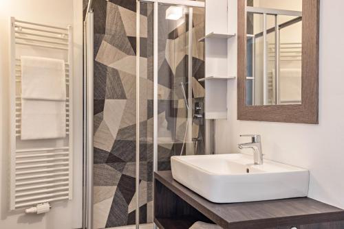 a bathroom with a sink and a shower at Apartment Dui Residence Bun Ste in San Vigilio Di Marebbe