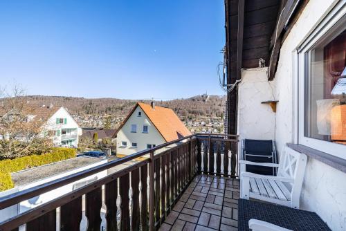 a white chair sitting on a balcony with a view at Ferienwohnung Sonnenblick in Albstadt