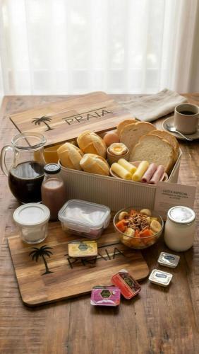a tray of bread and other food on a table at Pousada Contêiner 10 in Serra