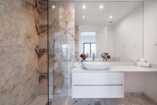 a bathroom with a sink and a shower at Luxury T2 Apartment With Ocean View in Portimão