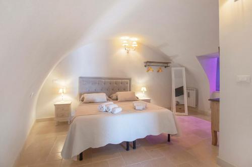 a bedroom with a bed with two towels on it at Casa Tuccia in Ostuni