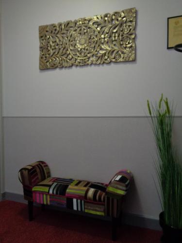 a couch in a room with a painting on the wall at Hotel de Montaulbain in Verdun